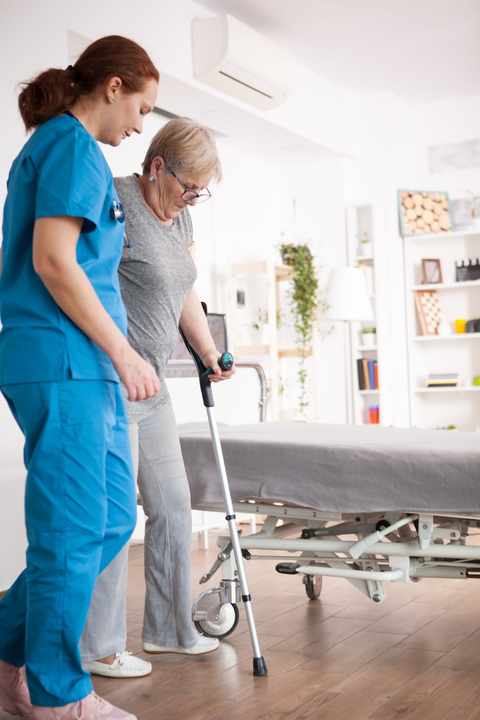 Nurse helping elderly woman at home