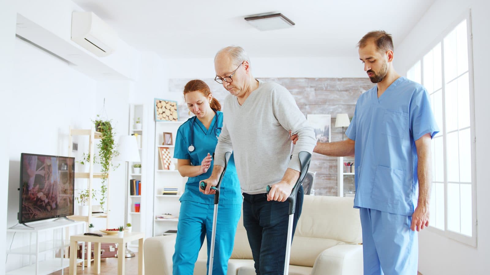Skilled nursing team assisting patient with mobility